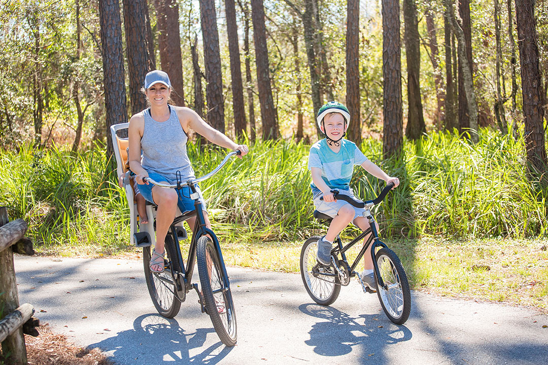 Mother and son biking on a bike path